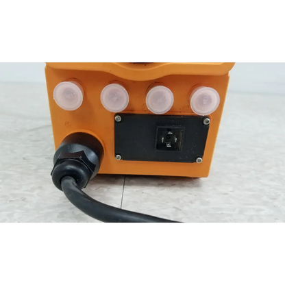 Orange plastic ProMinent Gamma X GMXA 1009 diaphragm metering pump with four white caps and black electrical plug