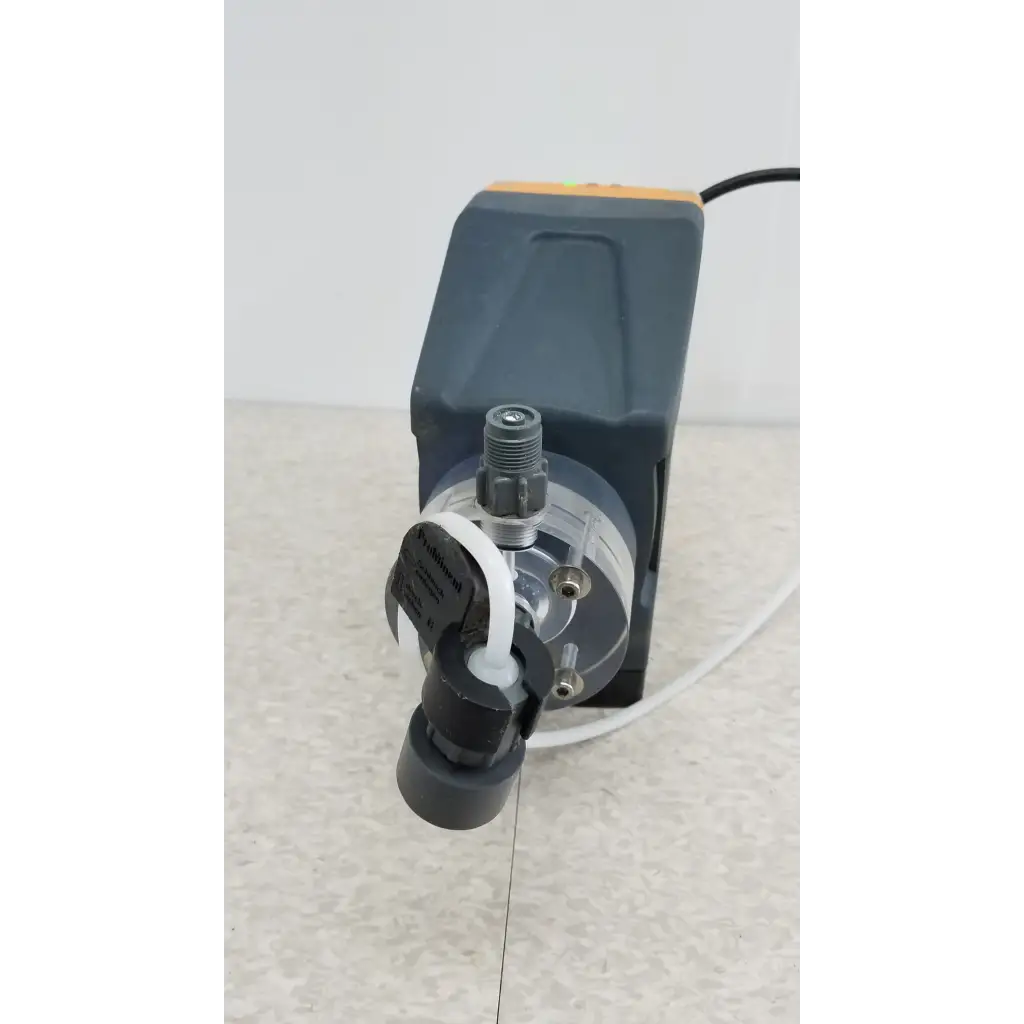 ProMinent Gamma X GMXA 1009 gray and orange diaphragm metering pump with transparent tubing and black fittings