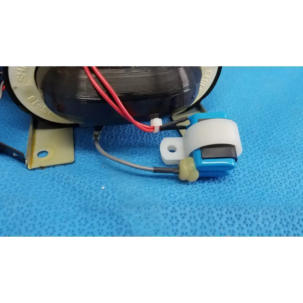 Blue and white plastic core power transformer with yellow connector attached to red and gray wires for retinal camera
