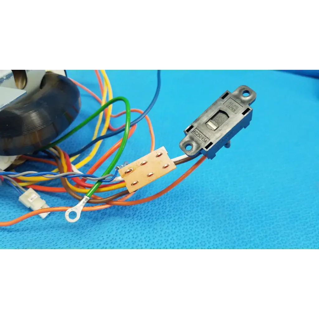 Black plastic toggle switch with metallic contacts and multicolored wires for core power transformer in retinal camera