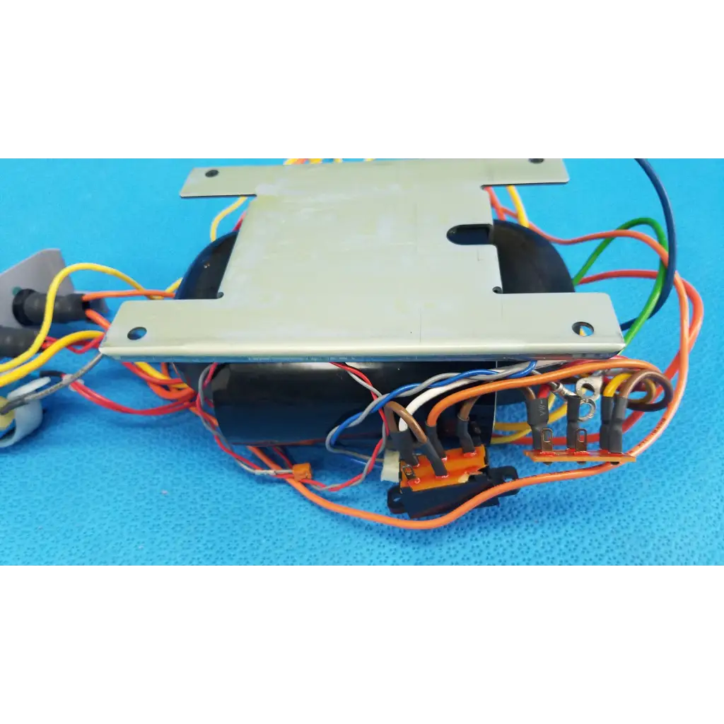 Black cylindrical core power transformer with silver metal plates and multicolored wires for retinal camera use