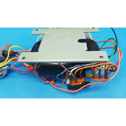 Black cylindrical core power transformer with silver metal plates and multicolored wires for retinal camera use