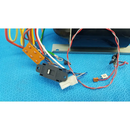 Black plastic toggle switch with colored wires connected to core power transformer for topcon retinal camera