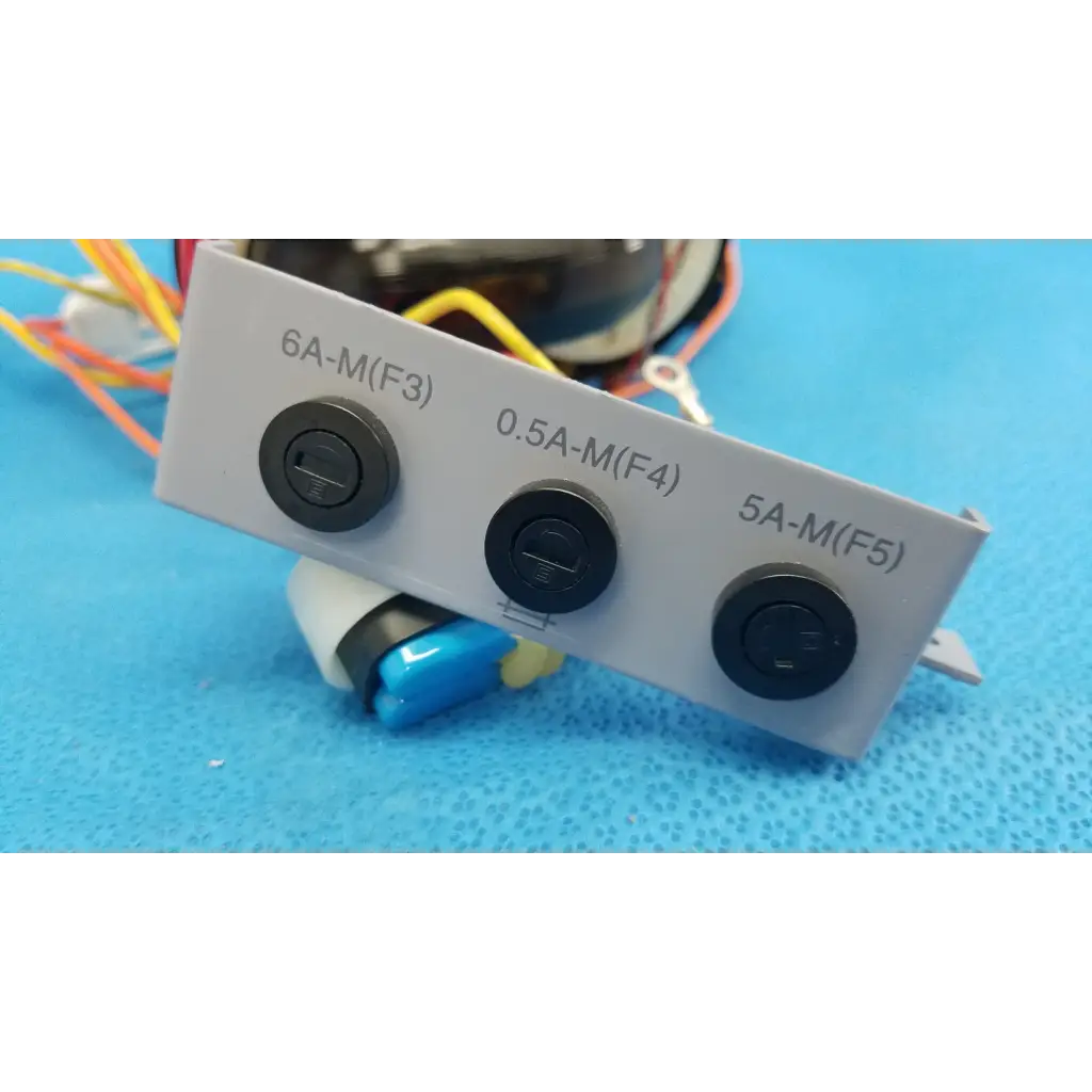 Gray electrical panel with three black switches on r core power transformer for topcon trc-nw6s retinal camera