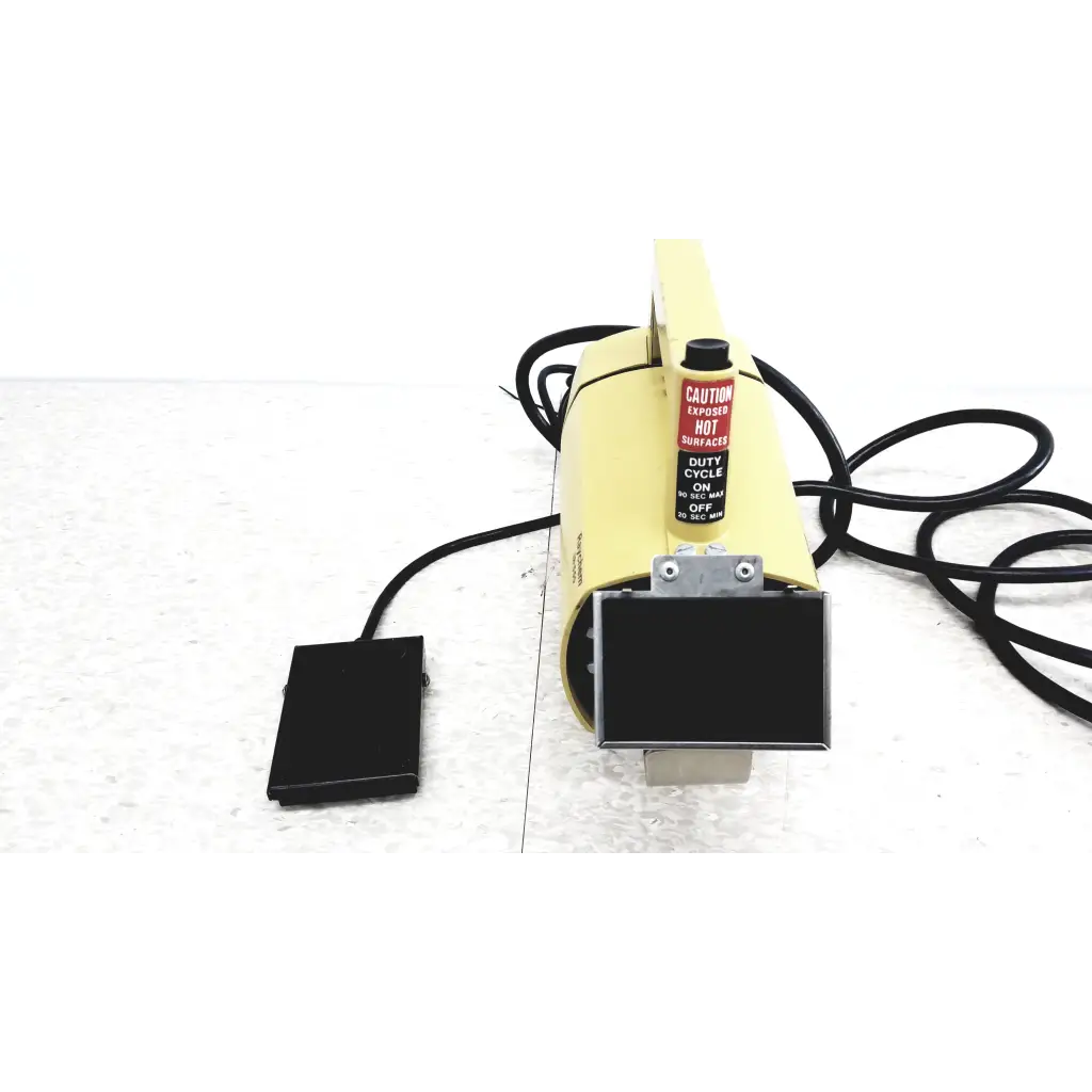 Raychem IR-550 yellow infrared heat shrink station with black foot pedal and warning label for heat shrink applications
