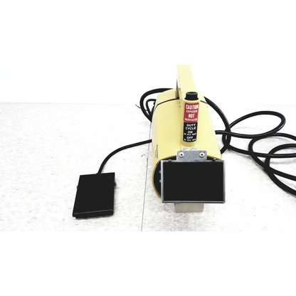 Raychem IR-550 yellow infrared heat shrink station with black foot pedal and warning label for heat shrink applications