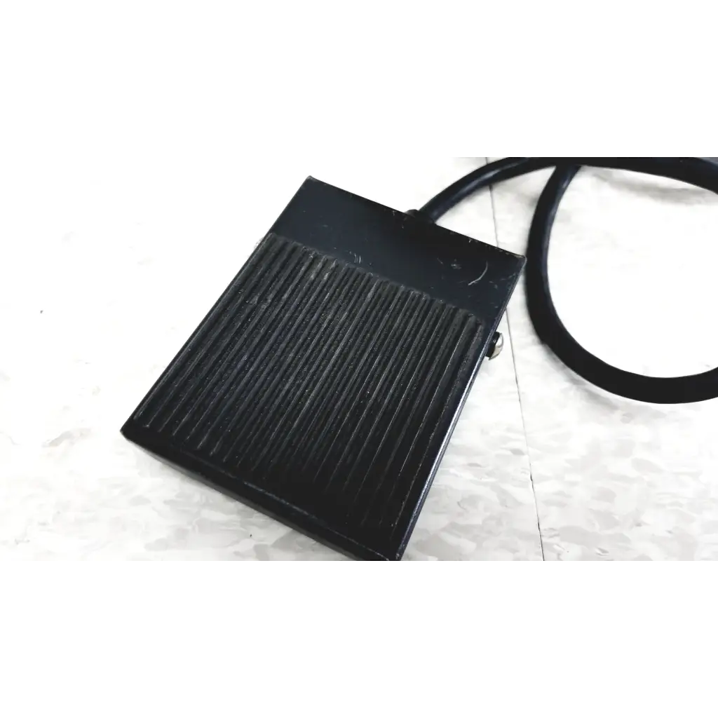 Black rectangular foot pedal with ribbed texture and cord for Raychem IR-550 infrared heat shrink station