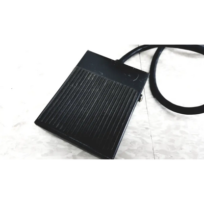 Black rectangular foot pedal with ribbed texture and cord for Raychem IR-550 infrared heat shrink station