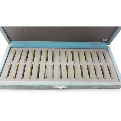 A resonance technology set of prescription eyeglass lenses in a light blue velvet-lined case labeled by diopter strength
