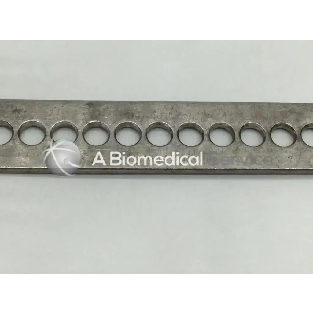 A metallic rectangular nephew deep blade with circular holes and biomedical logo for self-retaining retractor use