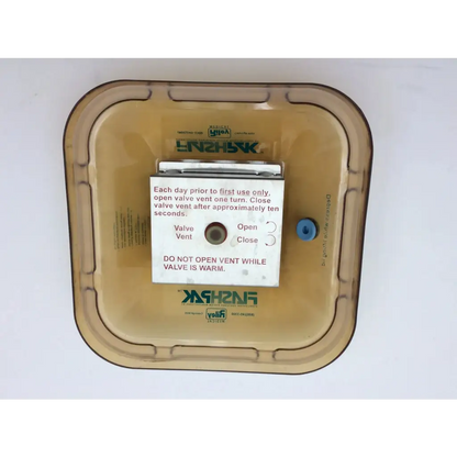 Tan plastic housing of riley medical flag pak 9020 sterilizer with white instruction label and small blue valve knob