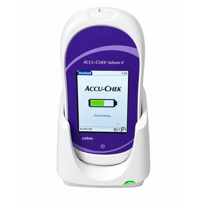 White and purple roche cobas accu-chek inform ii glucose meter with digital battery display docked in charging base