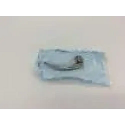 A silver stainless steel laryngoscope fiber optic blade with curved design inside clear plastic packaging