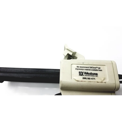 Beige plastic s-50 cartridge impression gun with black handle and westone laboratories label for ergonomic material cartridges
