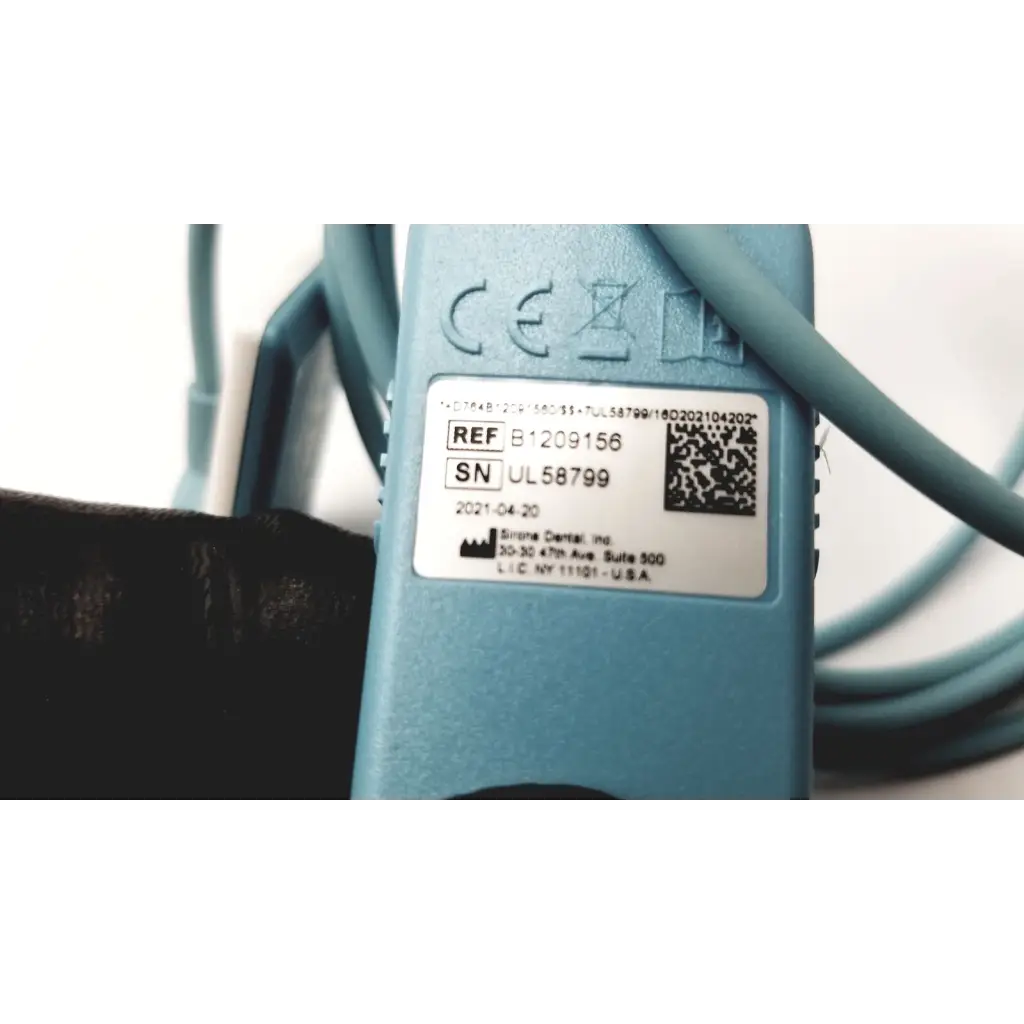 Light blue plastic schick elite sirona replacement cable with coiled design and white label showing serial numbers