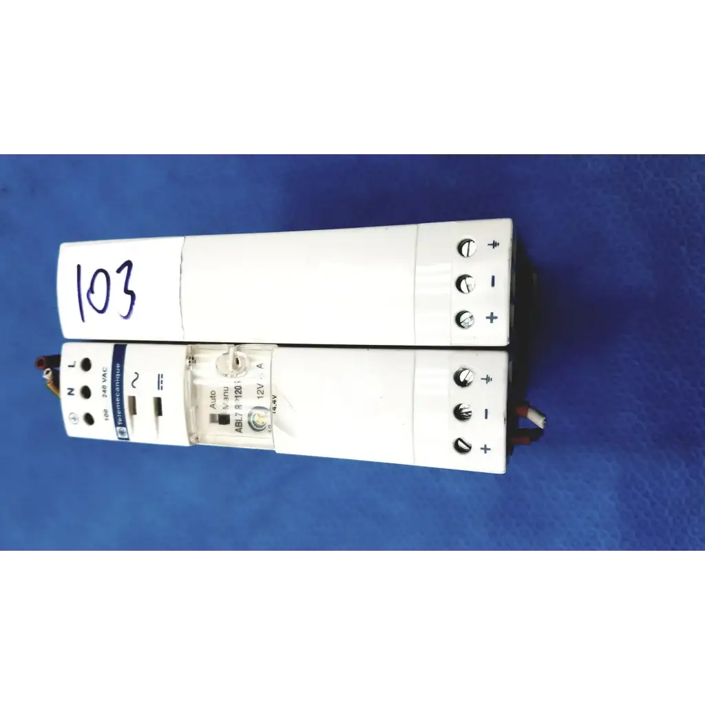 White rectangular schneider electric abl7 rp1205 switch mode power supply with labeled terminals and indicator lights