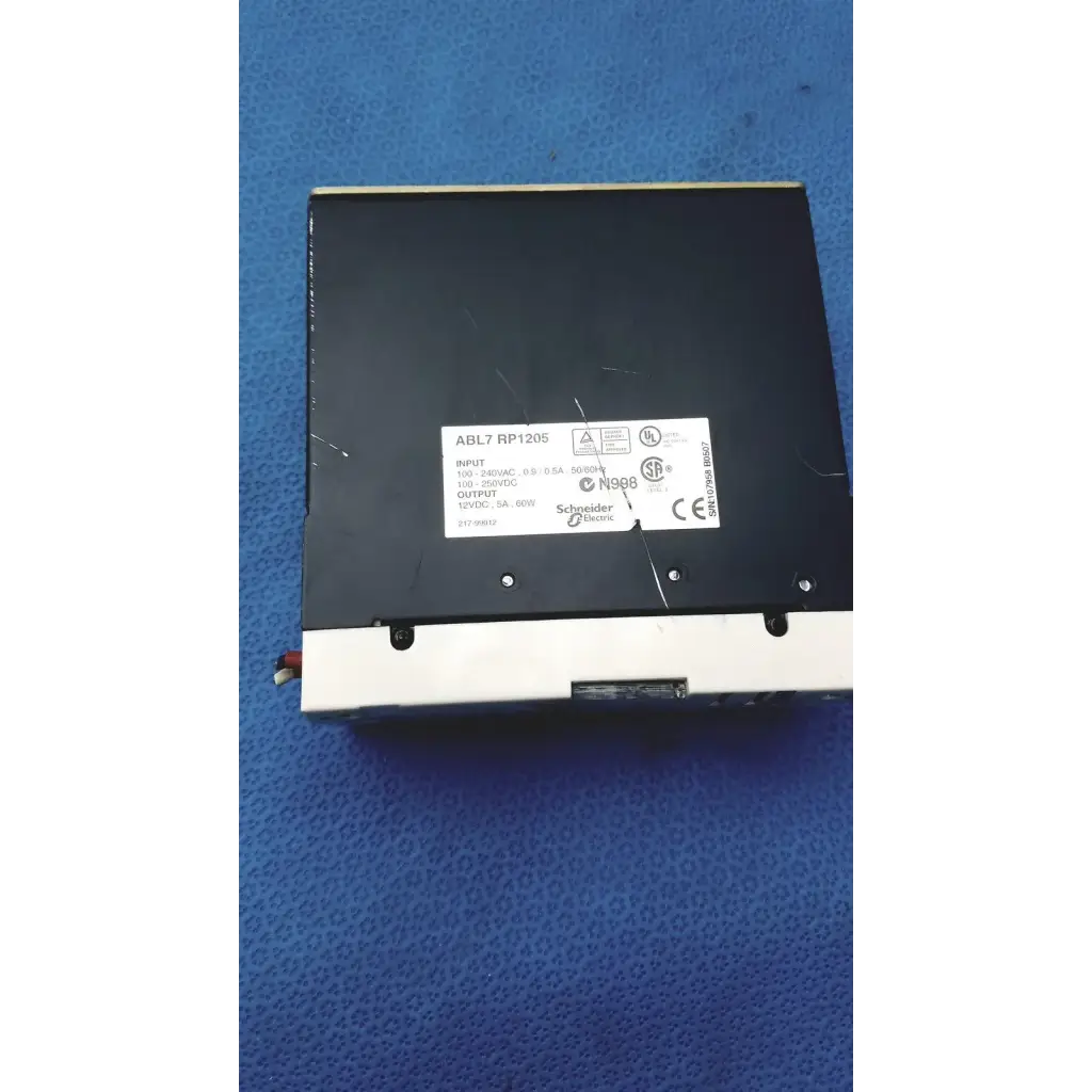 Black rectangular schneider electric abl7 rp1205 switch mode power supply with white label and technical specifications