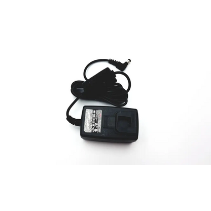 Black plastic seca medical power supply with coiled power cord and cylindrical connector for medical power use