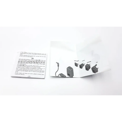 White paper packaging for a black seca medical power supply with multiple international plugs illustrated on the front