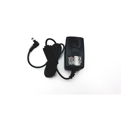 Black plastic seca medical power supply with coiled power cord and angled connector for medical power use