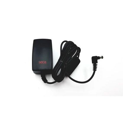 Black plastic seca medical power supply with coiled cord and angled connector for medical power use