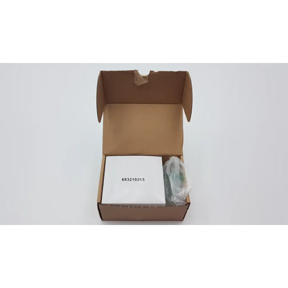 White rectangular seca medical power supply with black serial number inside open brown cardboard packaging