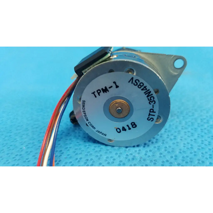 Silver-colored internal shutter stepper motor with black wiring and model tpm-1 label for topcon retinal camera