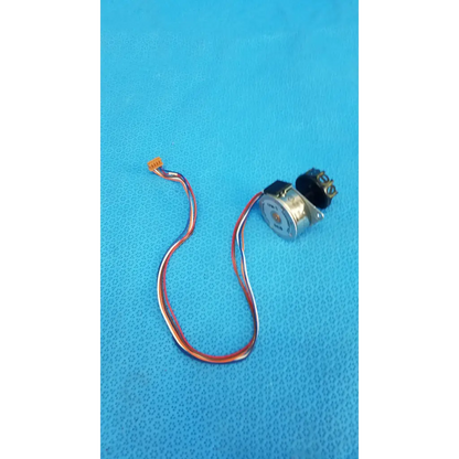 Silver-colored internal shutter stepper motor with black gear housing and red white blue wires for retinal camera
