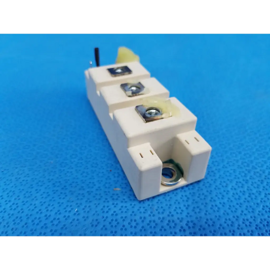 White ceramic semikron skm195gb066d igbt power module with three silver terminal screws and black wire on top