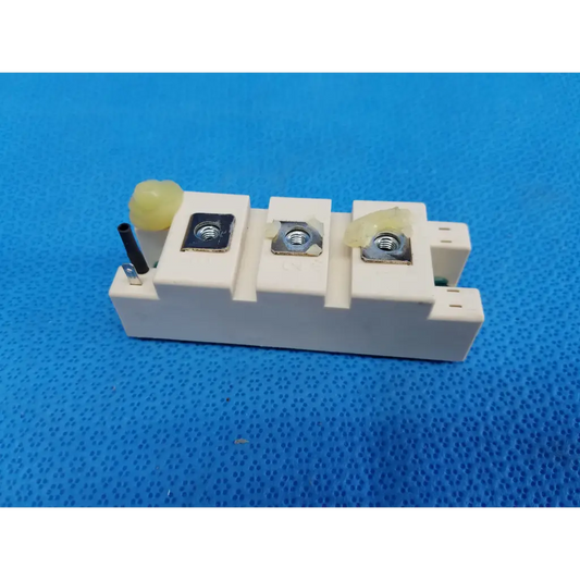 White ceramic semikron skm195gb066d semitrans m igbt power module with three metallic terminal screws and yellow insulating caps