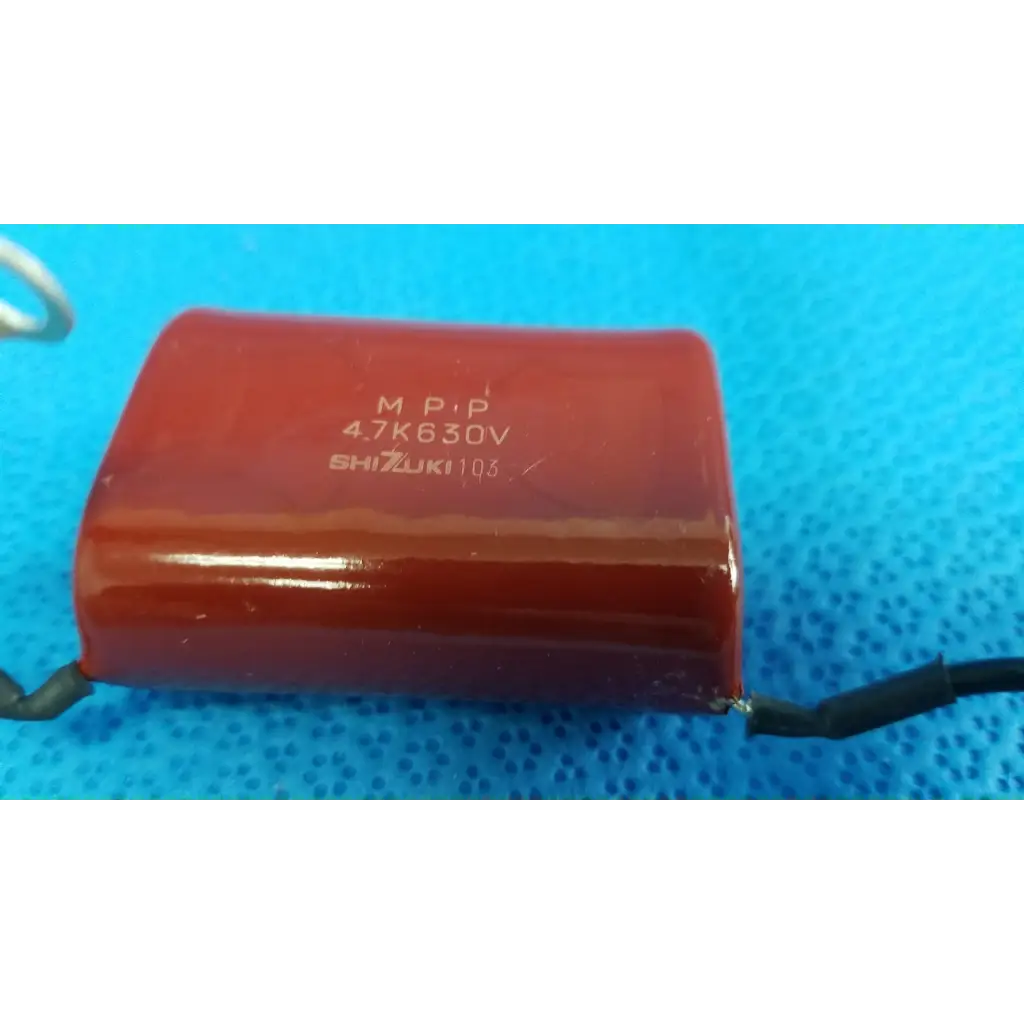 Red cylindrical high-voltage film capacitor with black leads and printed specs for topcon trc-nw8 retinal camera