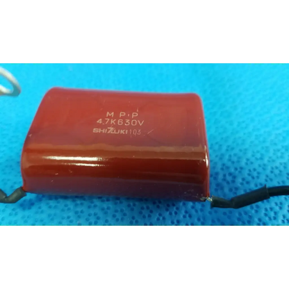 Red cylindrical high-voltage film capacitor with black leads and printed specs for topcon trc-nw8 retinal camera