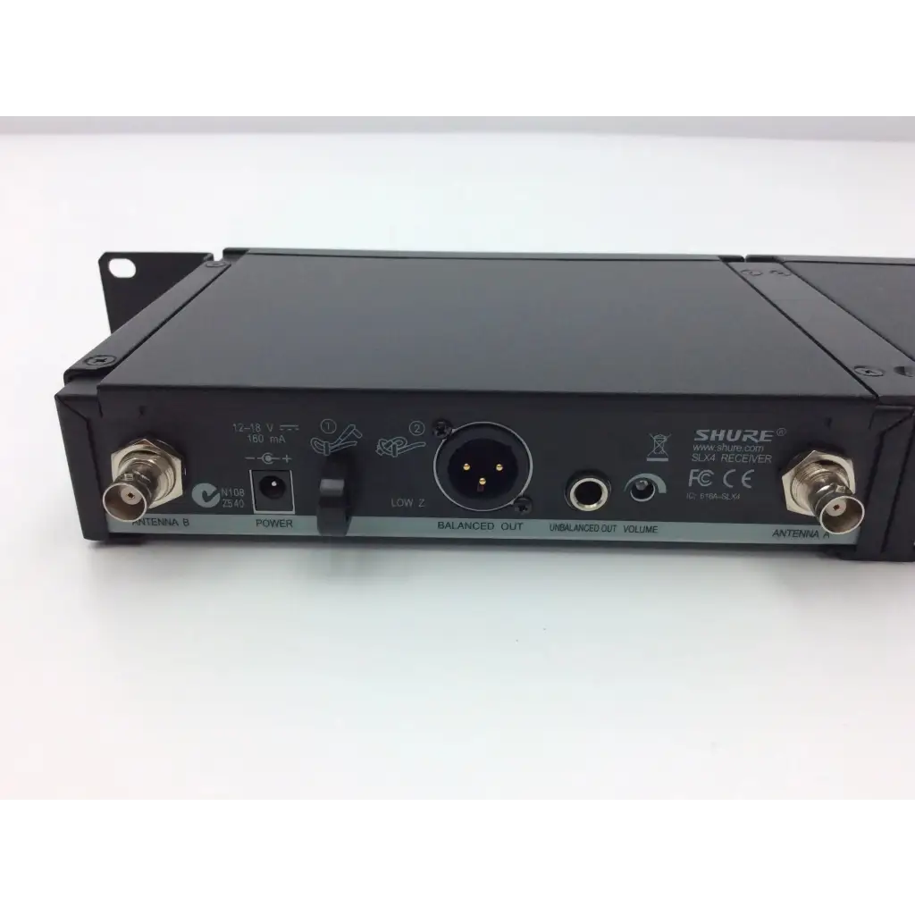 Black shure slx4 diversity receiver back with metallic connectors and labeled ports for wireless audio systems