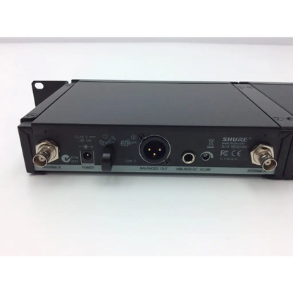 Black shure slx4 diversity receiver back with metallic connectors and labeled ports for wireless audio systems