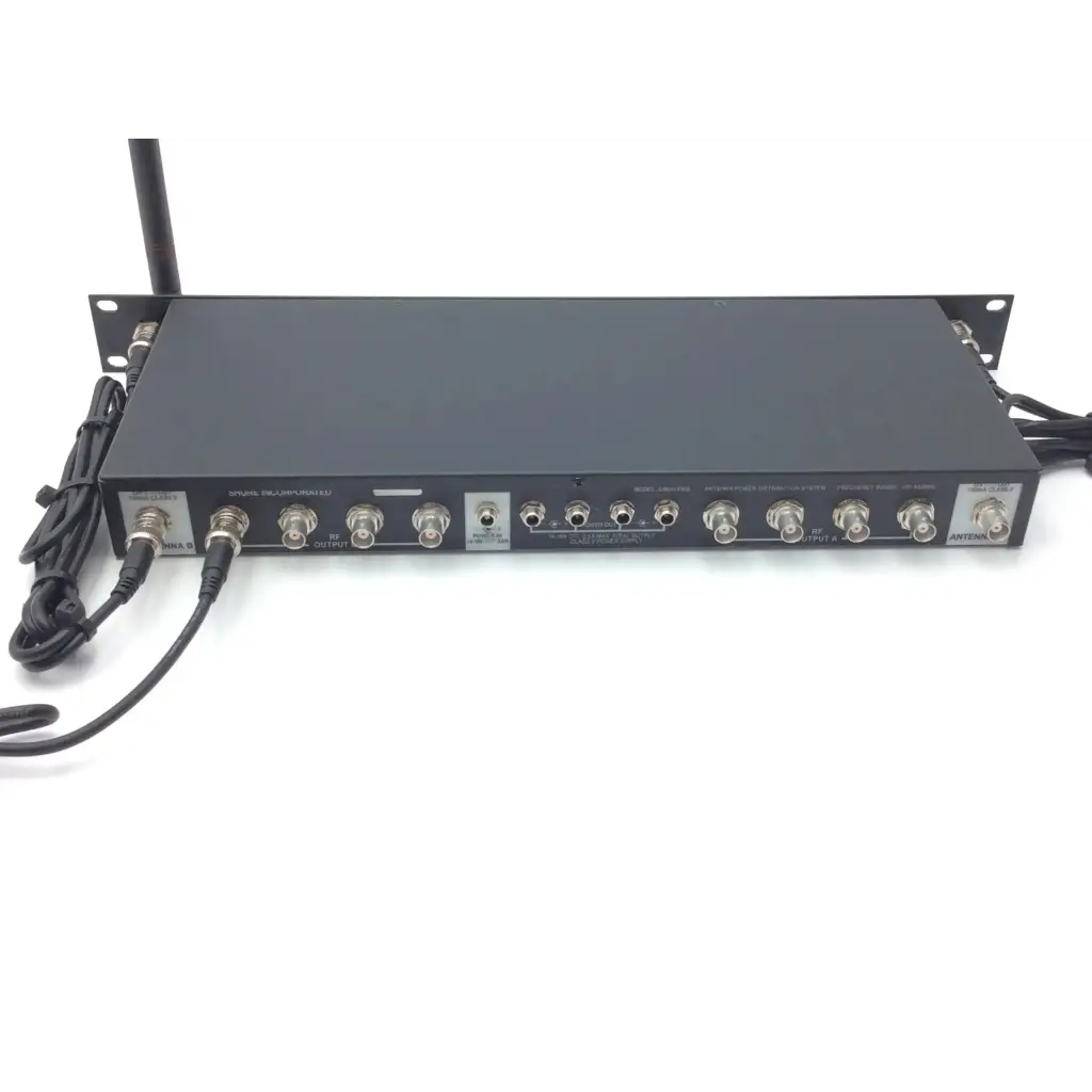 Black metal rack-mountable shure ua844 uhf antenna with multiple bnc and 3.5mm ports and labeled signal inputs on back side