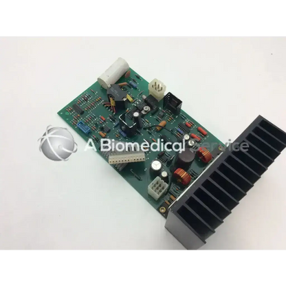 Green power supply board assembly with various electronic components and black heat sink for efficient cooling