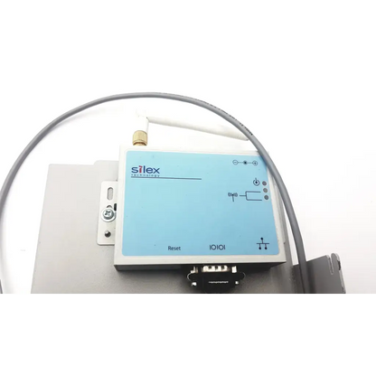 Light blue rectangular silex technology 75505r wireless serial server with white antenna and silver mounting bracket