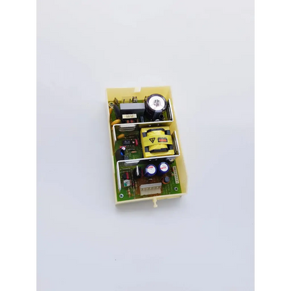 Yellow plastic housing with green circuit board and electronic components in snp-9549-m1 nibp assembly board