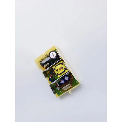 Yellow plastic housing with green circuit board containing capacitors resistors and inductor in skynet snp-9549-m1 power supply