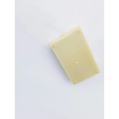 A pale yellow rectangular plastic housing with four screws and central hole for snp-9549-m1 power supply back side