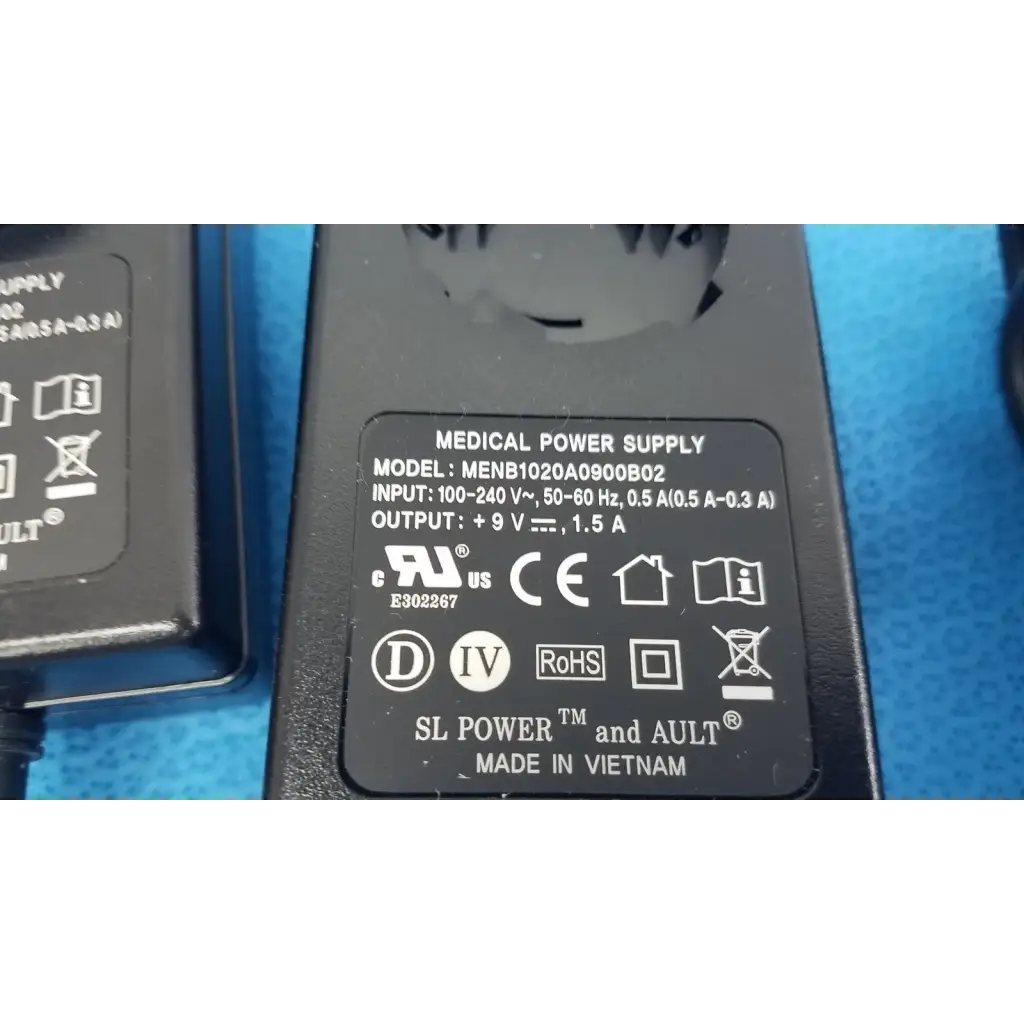 Black plastic medical power supply menb1020a0900b02 with 9v 1.5a output and ul ce certifications on label