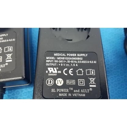 Black plastic medical power supply menb1020a0900b02 with 9v 1.5a output and ul ce certifications on label