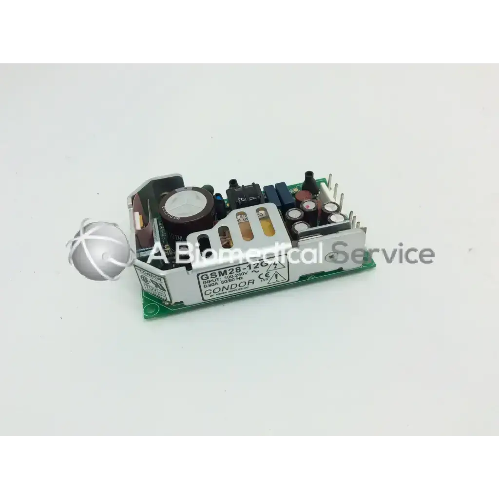 Silver and black gsm28 28w power supply module with capacitors and circuitry on a green power electronics board