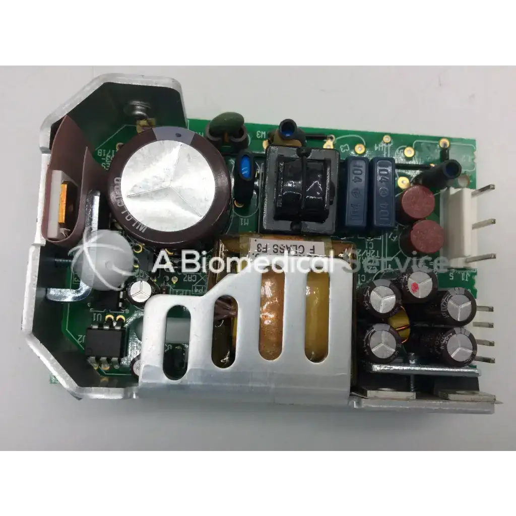 Green circuit board with silver and black components including capacitors and large inductor for gsm28 28w power supply