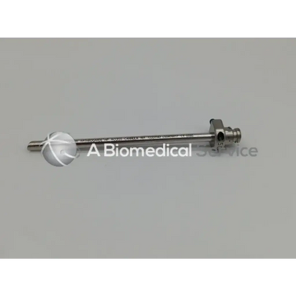 Silver arthrograde hip access cannula with spherical tip and threaded end featuring engraved text on shaft
