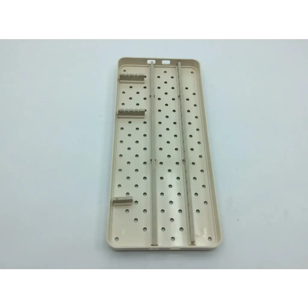 Beige plastic surgical instrument tray with perforated surface and slots for nephew case hip arthroscopy aci-65 12731nj
