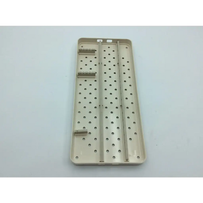 Beige plastic surgical instrument tray with perforated surface and slots for nephew case hip arthroscopy aci-65 12731nj