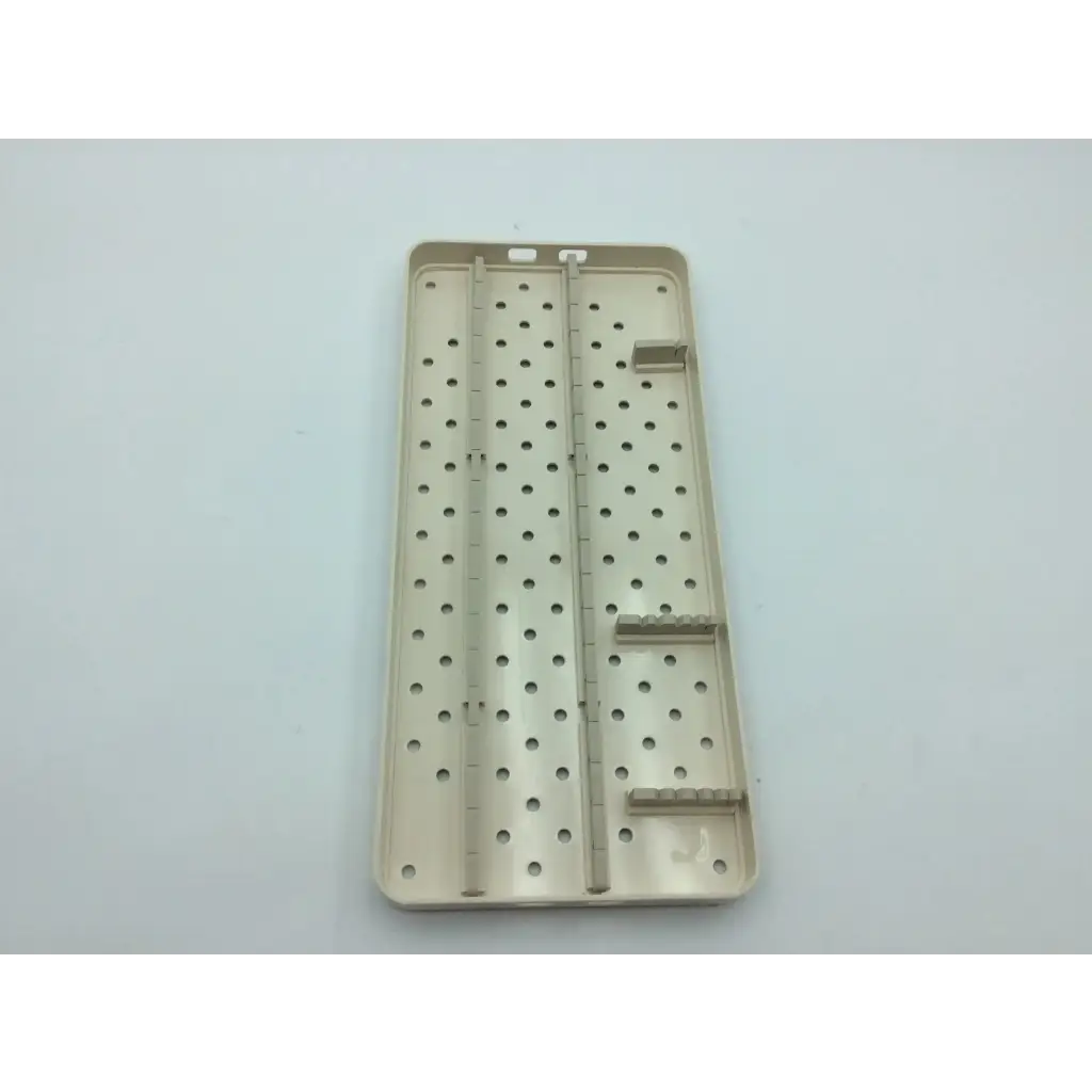 Beige plastic smith & nephew case tray with perforated surface and molded compartments for hip arthroscopy aci-65 12731nj