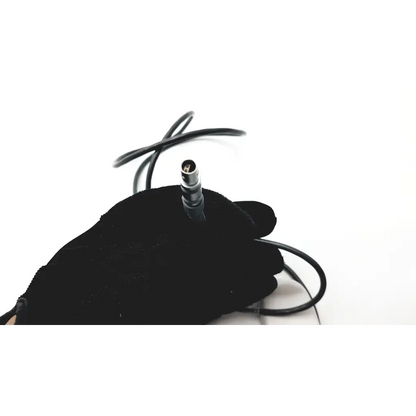 Black-gloved hand holding black cable with silver xlr connector for smiths medical cadd solis remote device