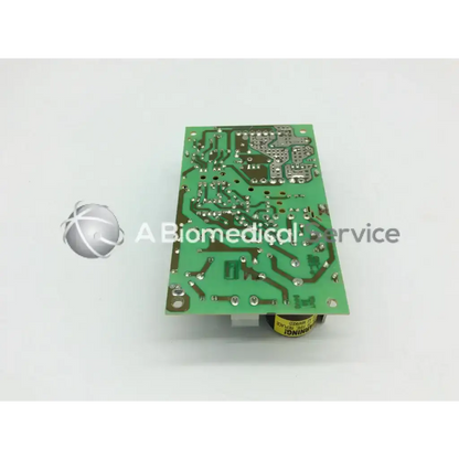Green rectangular printed circuit board with silver components and yellow capacitor for input 100-250vac~2-1a 47-63hz